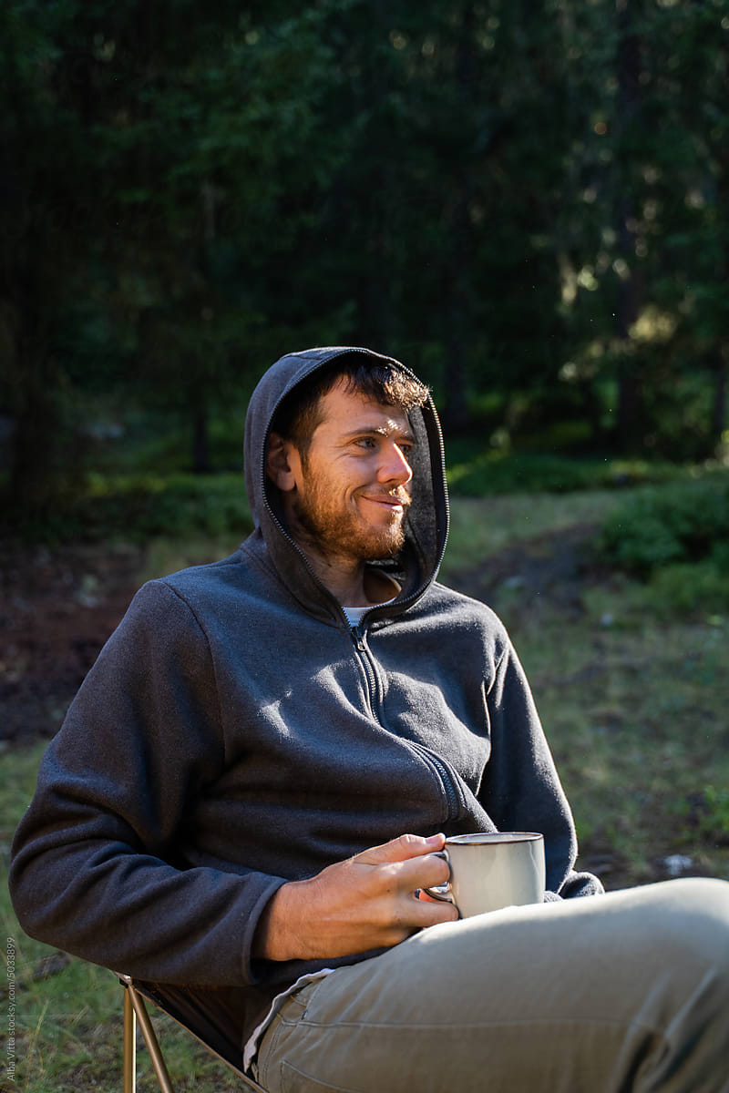 Camper Man with coffee in the forest