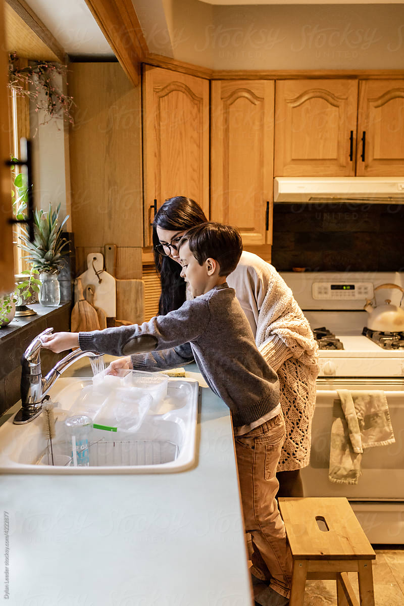 Mother Helps Son With Dishes