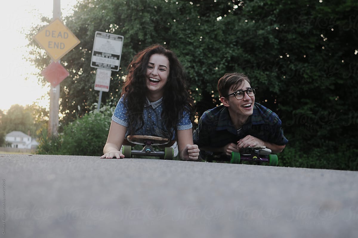A Young Couple Laughs By Stocksy Contributor Chelsea Victoria Stocksy
