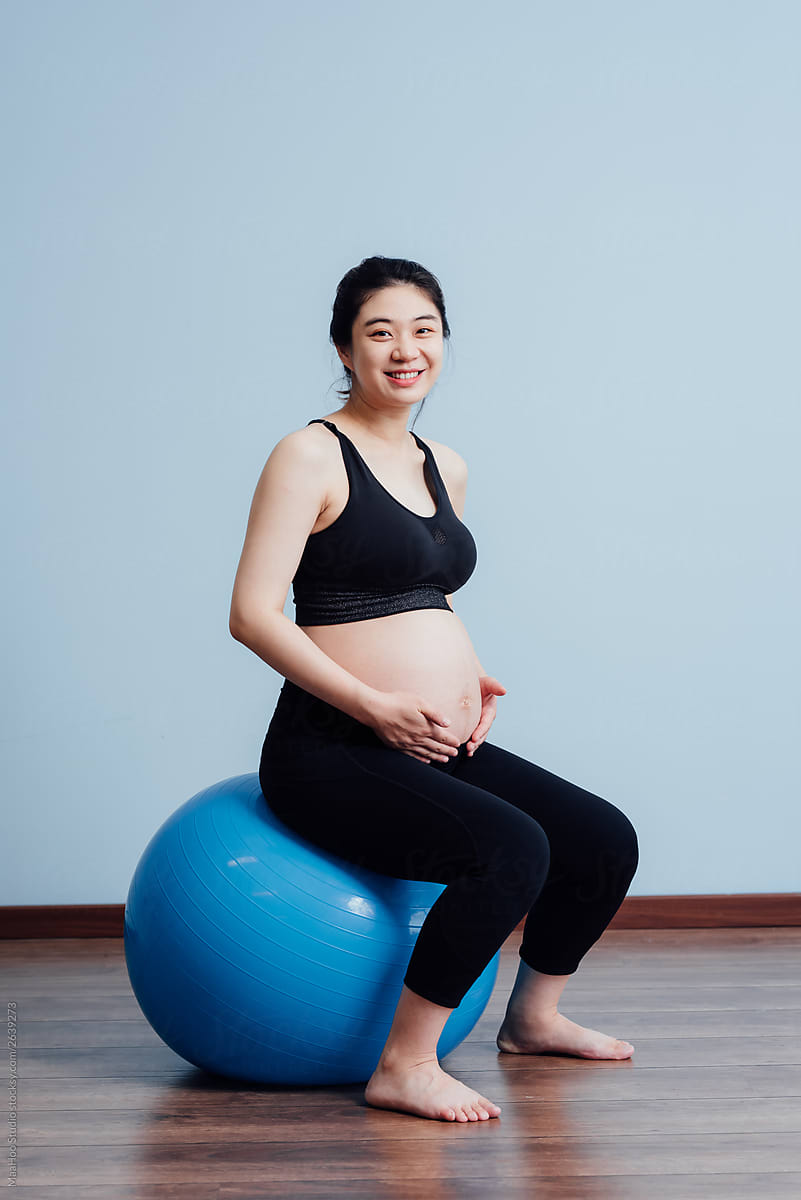 Young pregnant woman doing yoga