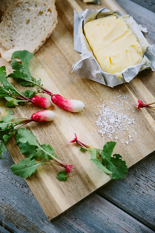 Bread, grass-fed butter and French Breakfast radishes on a board