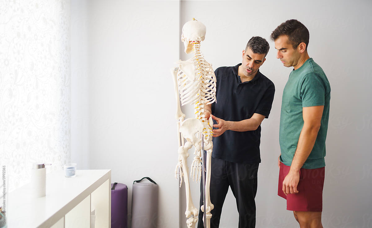 A physiotherapist explaining to a patient