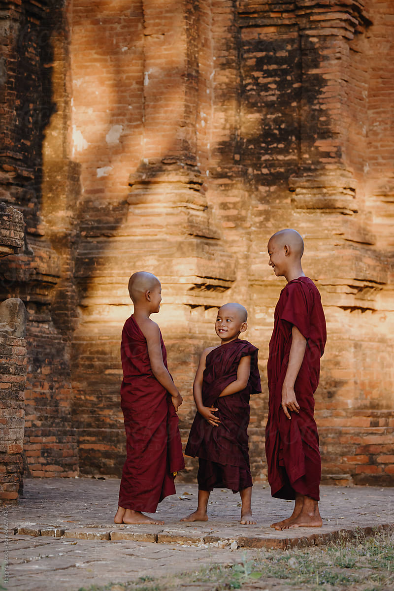Novice monks sharing a moment in temple ruins