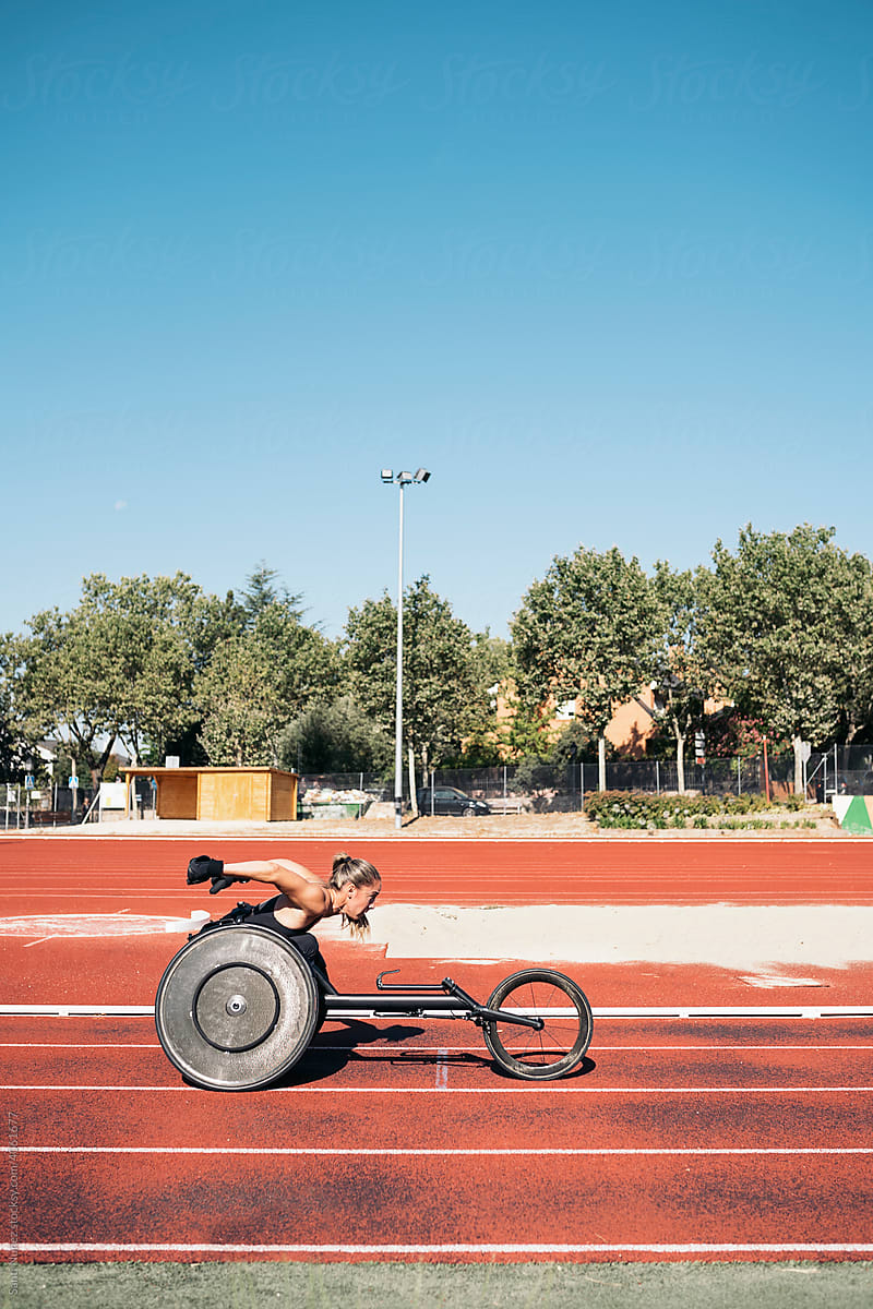 Female wheelchair athlete training on sports track
