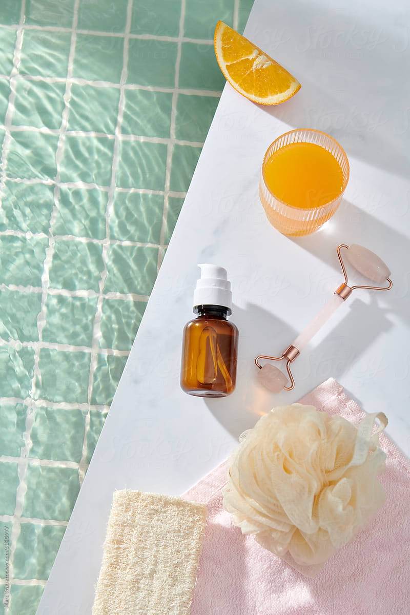 Cosmetic roller oil and citrus fruits with bath  accessories by pool
