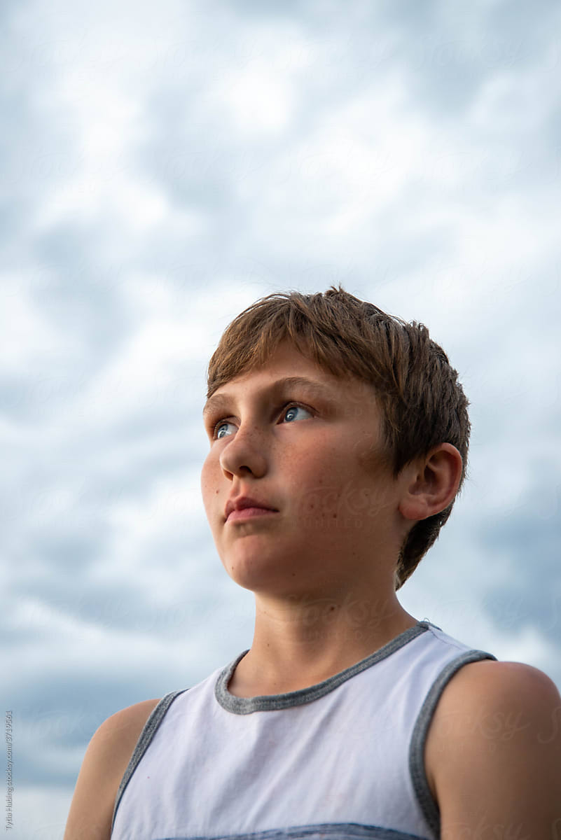 Portrait of Teen Boy with Clouds