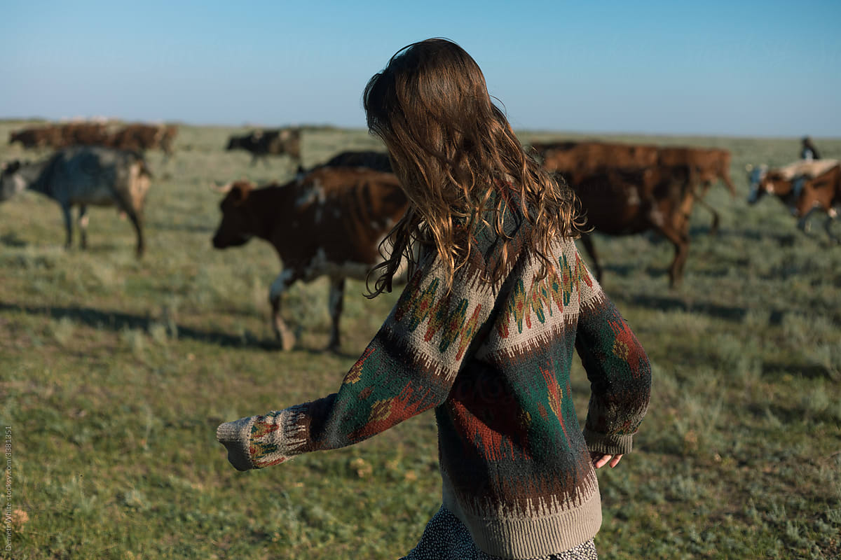girl on the background of cows