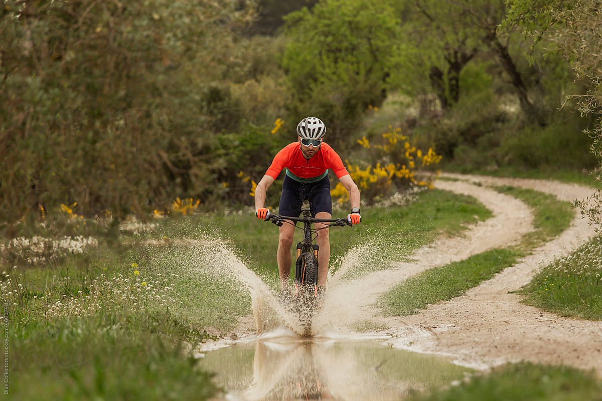 cyclist crossing a puddle of water