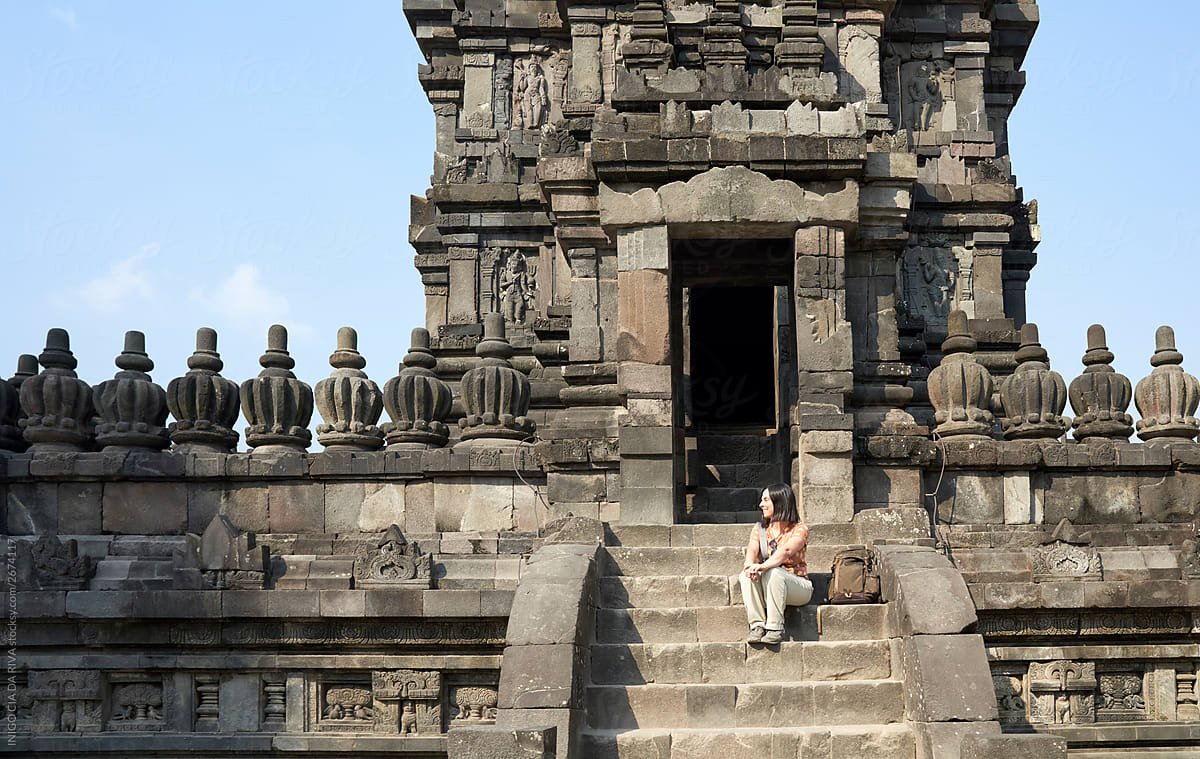 Traveling woman near Hindu temple