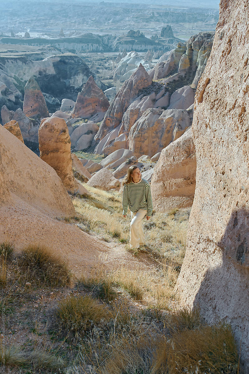 a woman walks along a scenic trail