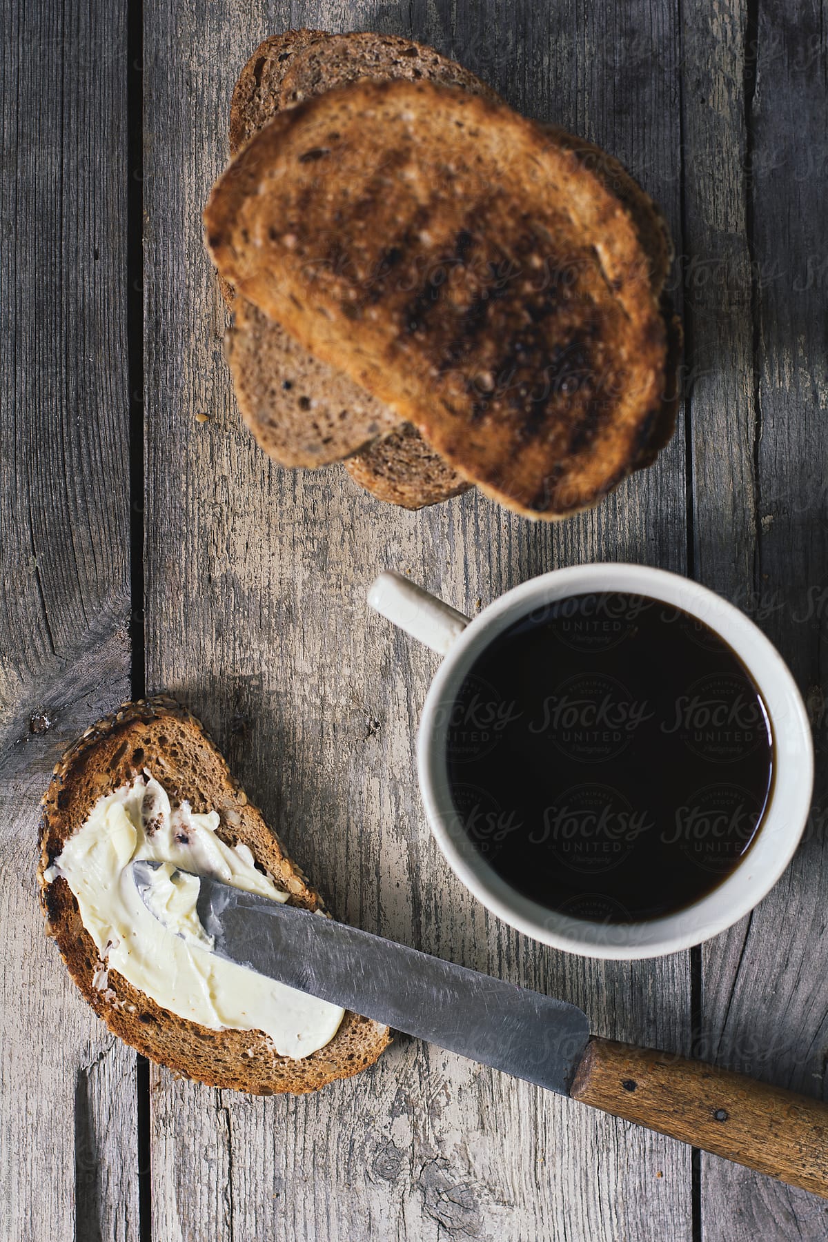 Simple breakfast with toasts, butter and coffee