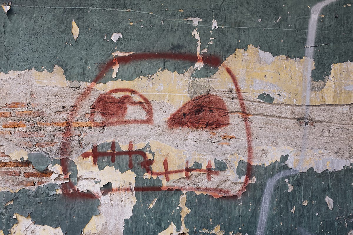 Graffiti Face Drawing On The Old Brick Wall