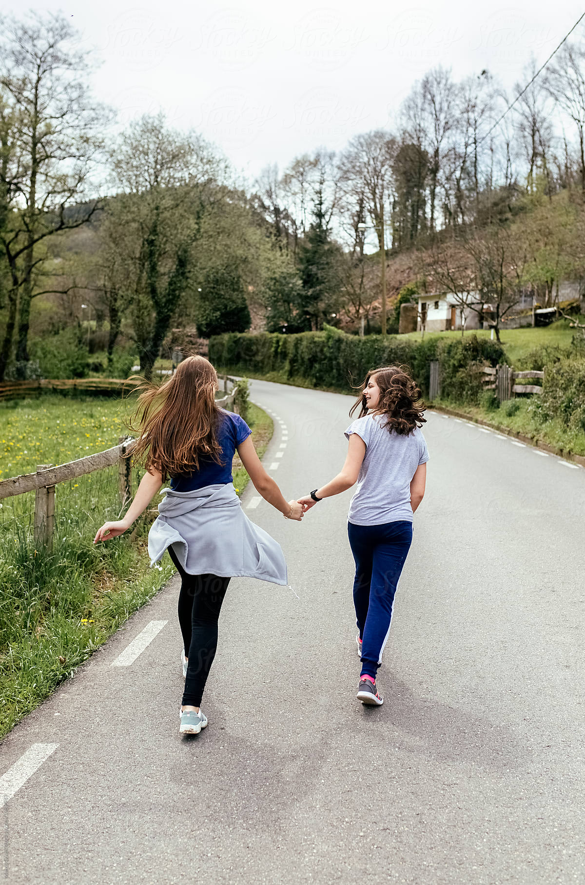 Two Teenage Girls Hiking On A Road By Stocksy Contributor Marco Govel Stocksy 