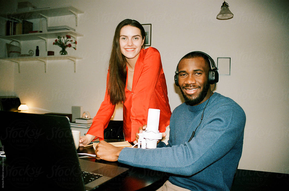 Film photo. A man and a woman record a podcast at home