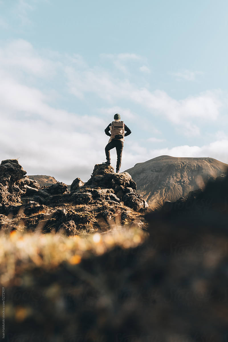 solitary hiker exploring volcanic mossy lava fields
