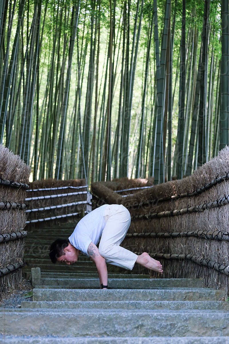 Yoga Crow Posing in front of bamboo forest