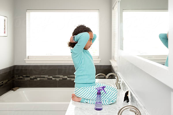 Girl Holding Scissors In Bathroom by Stocksy Contributor Jennifer Bogle  - Stocksy