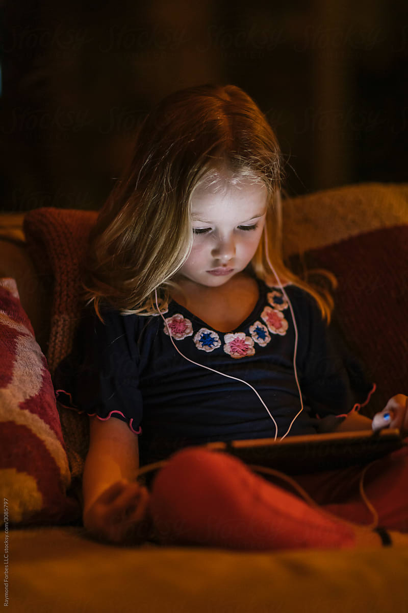 Young Girl on Tablet Computer at Night