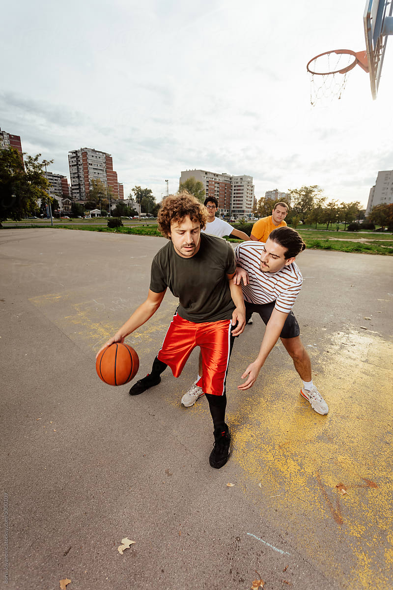 Men playing basketball outdoor