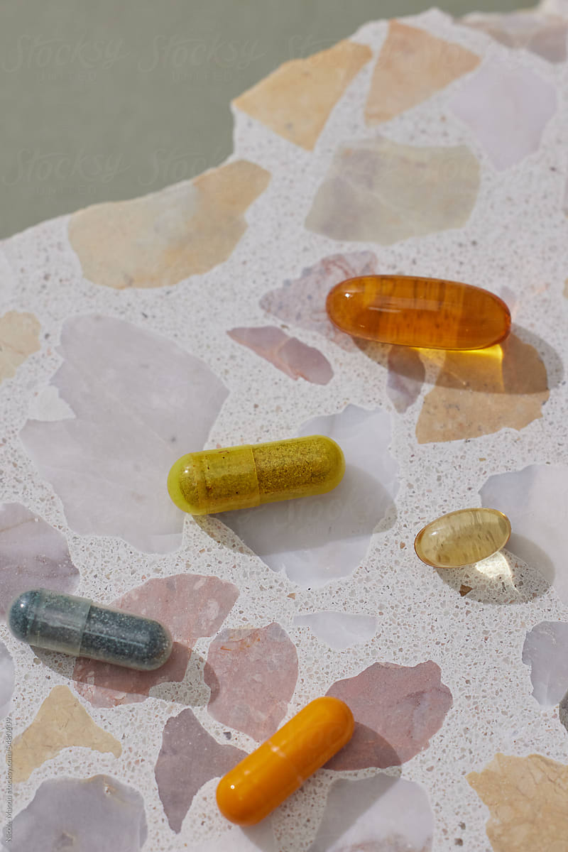 Vibrant Harmony: Colorful Supplement Pills on Terrazzo Surface