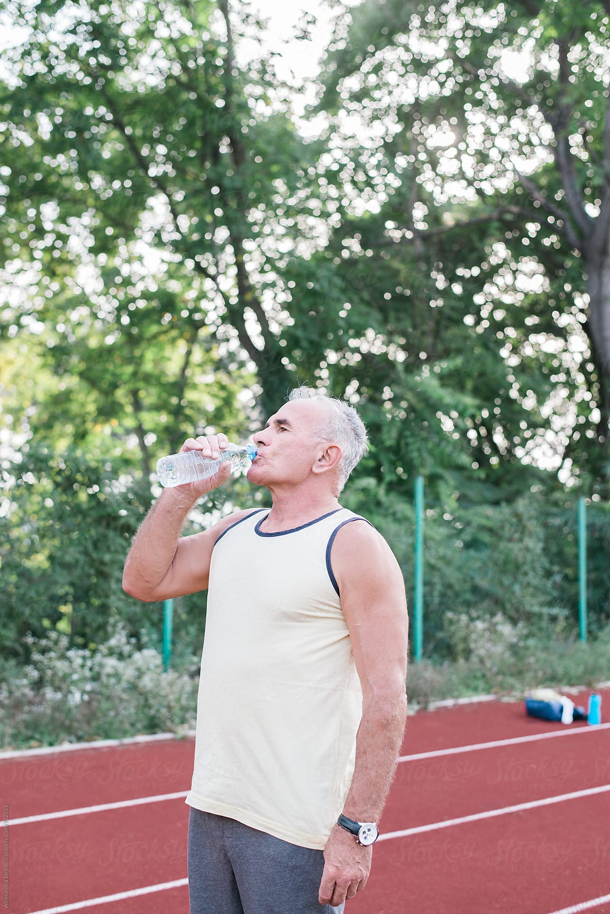 Senior Man Drinking Water After Jogging