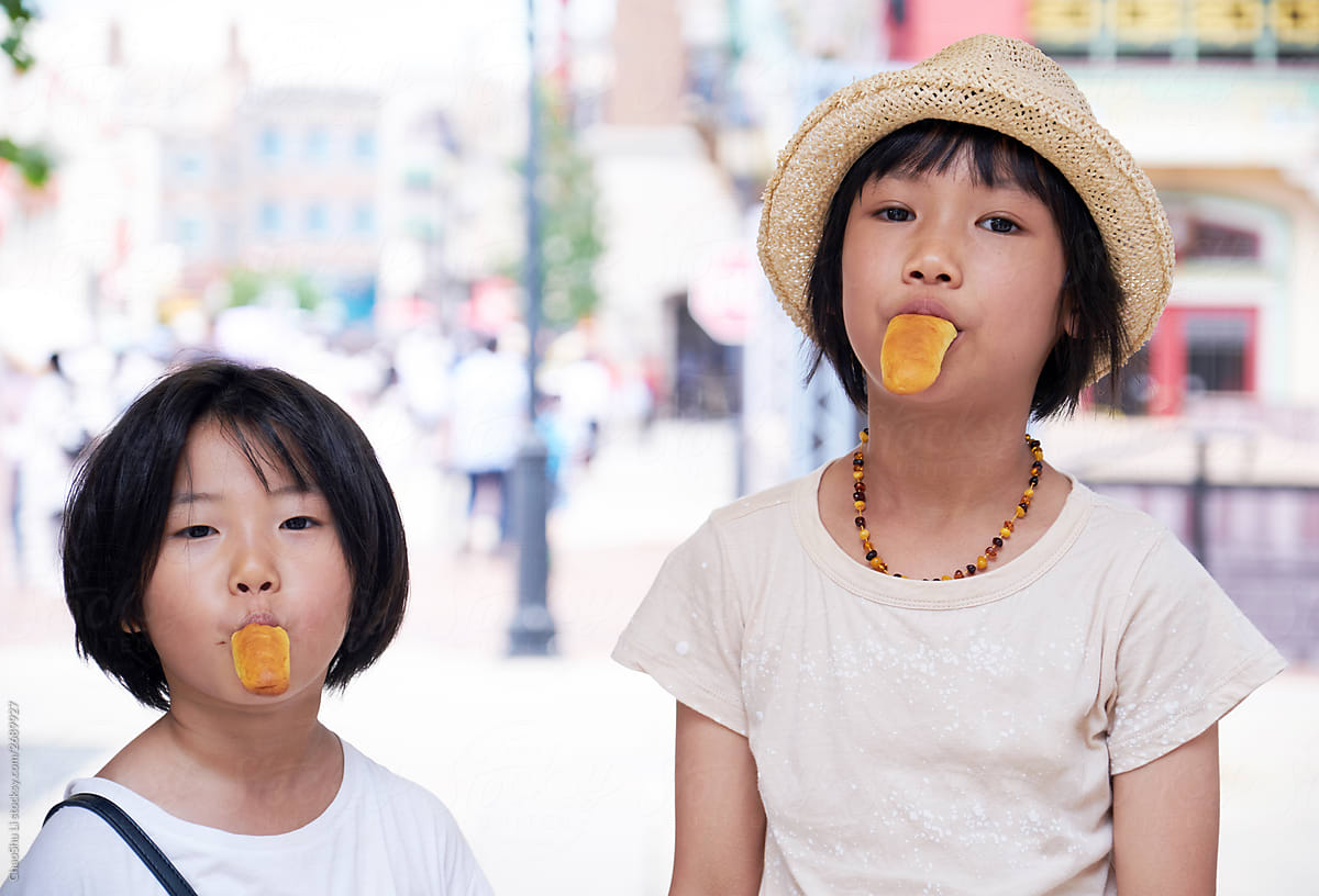 Asian little girls eating bread and weird