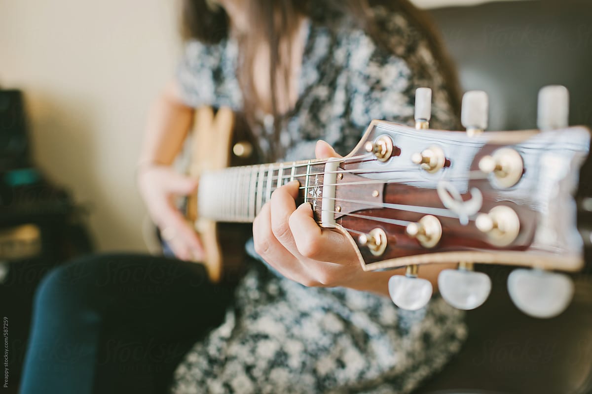 Teenage girl playing electric guitar