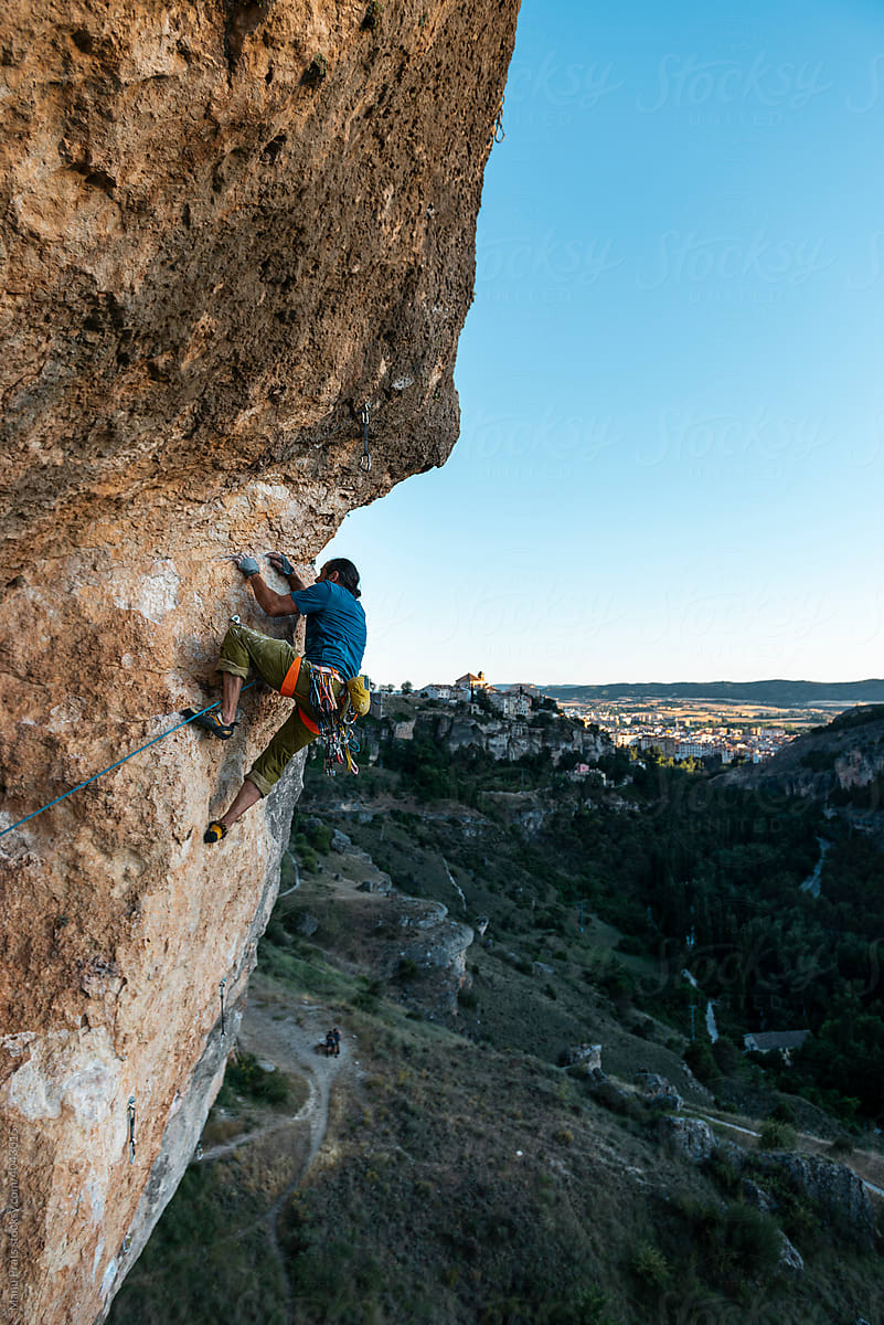 Mature climber climbing on crack