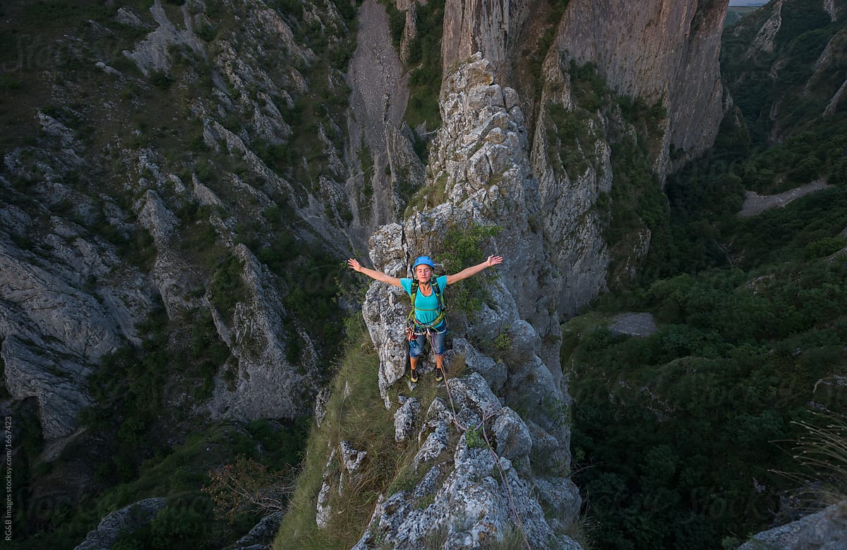 Female climber on top of mountian gorges