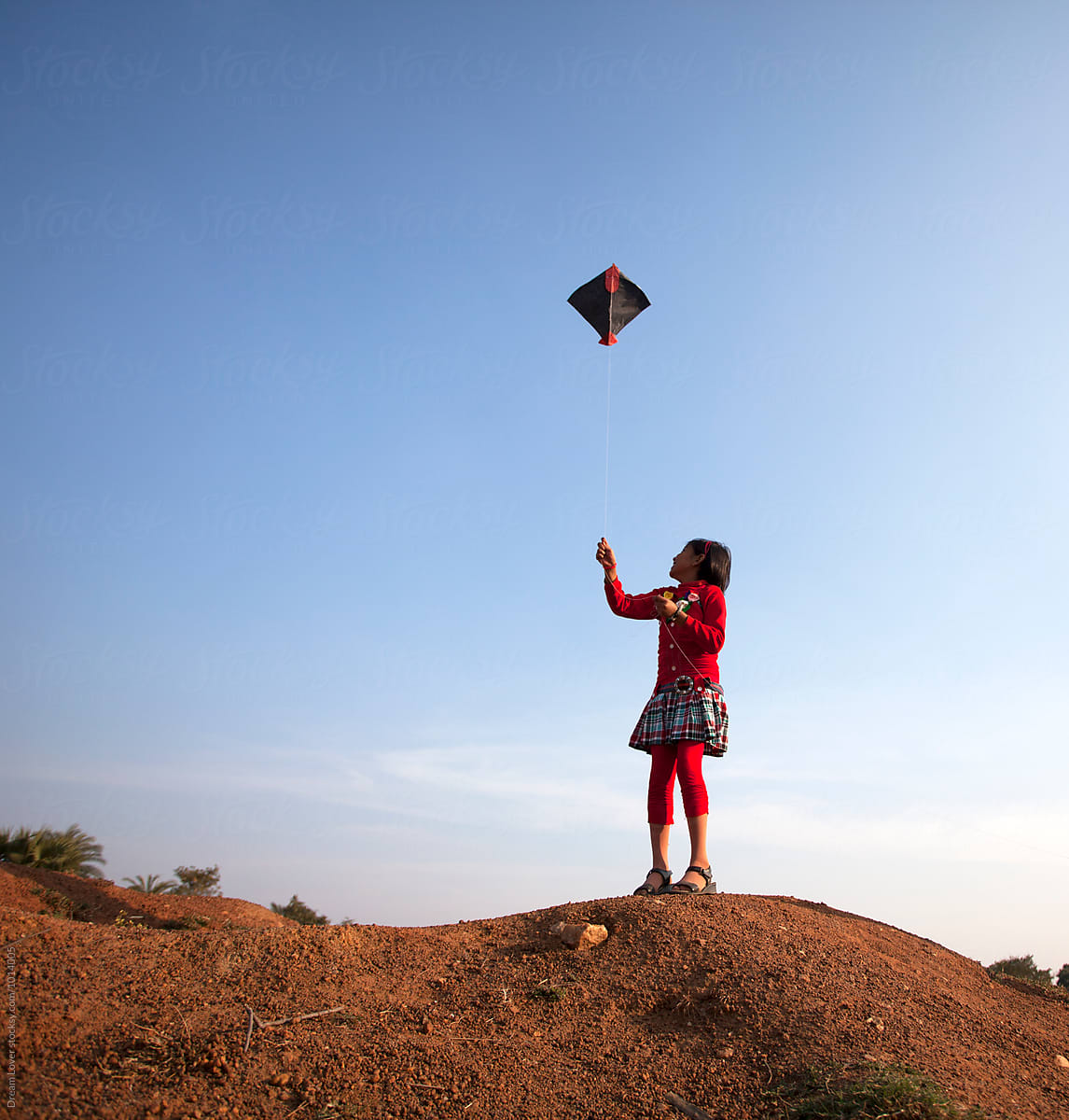 A little girl flying kite