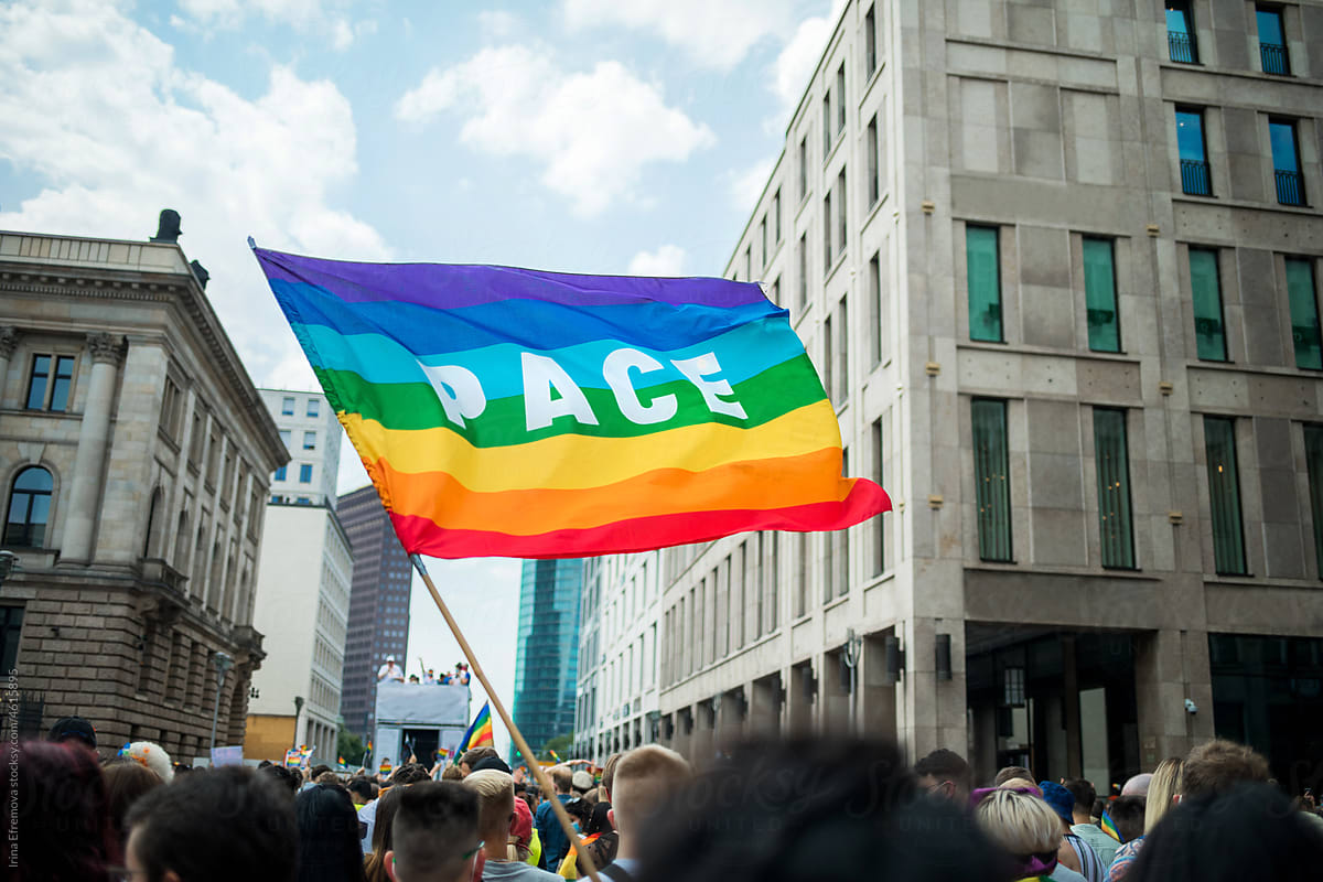 Pace flag waving during Pride Procession in the city centre