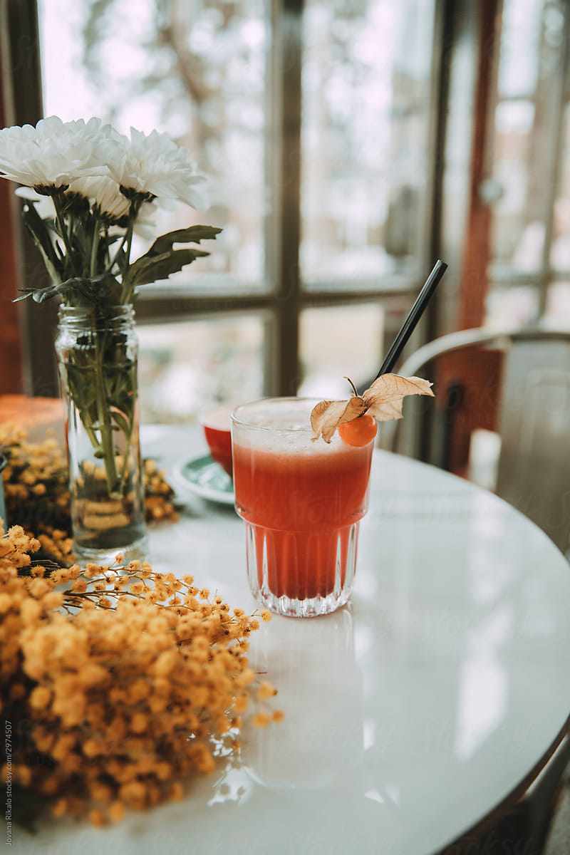 Raspberry juice  and table full of flowers