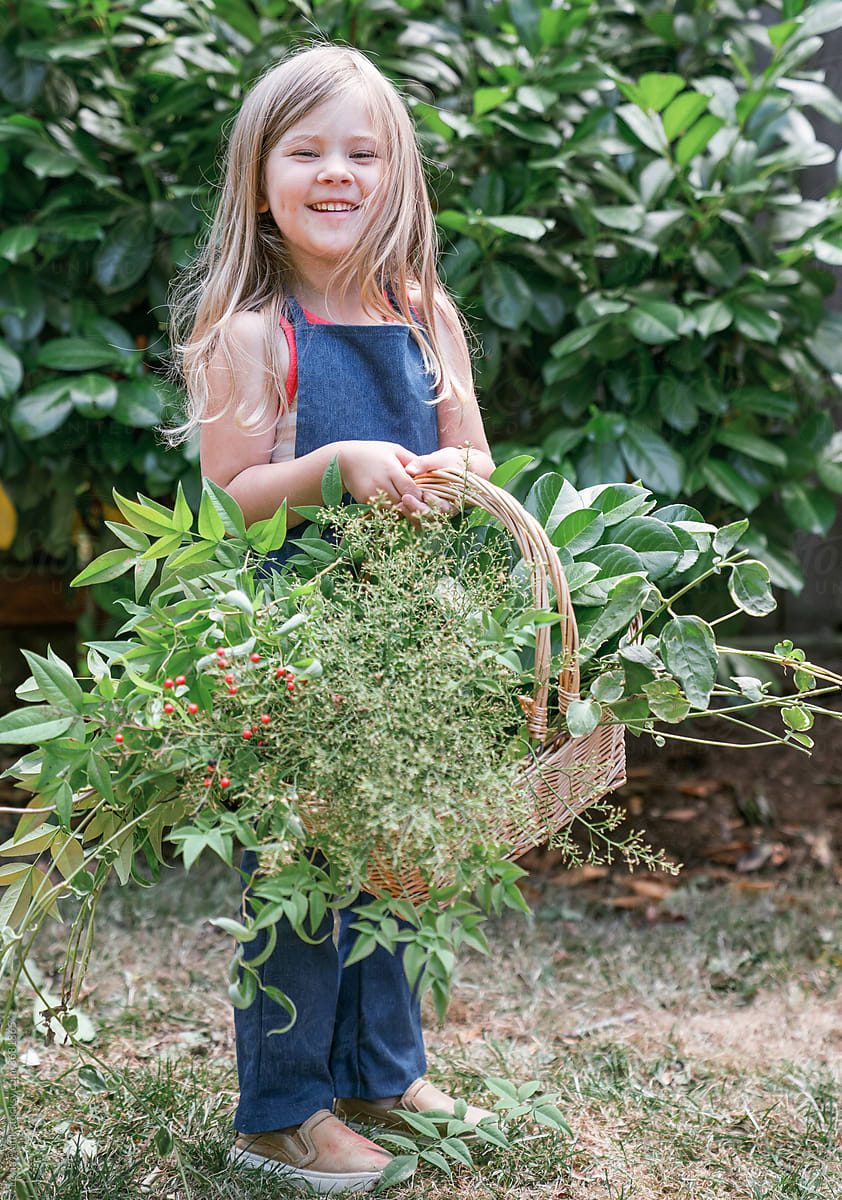 little girl with basket of foraged floral