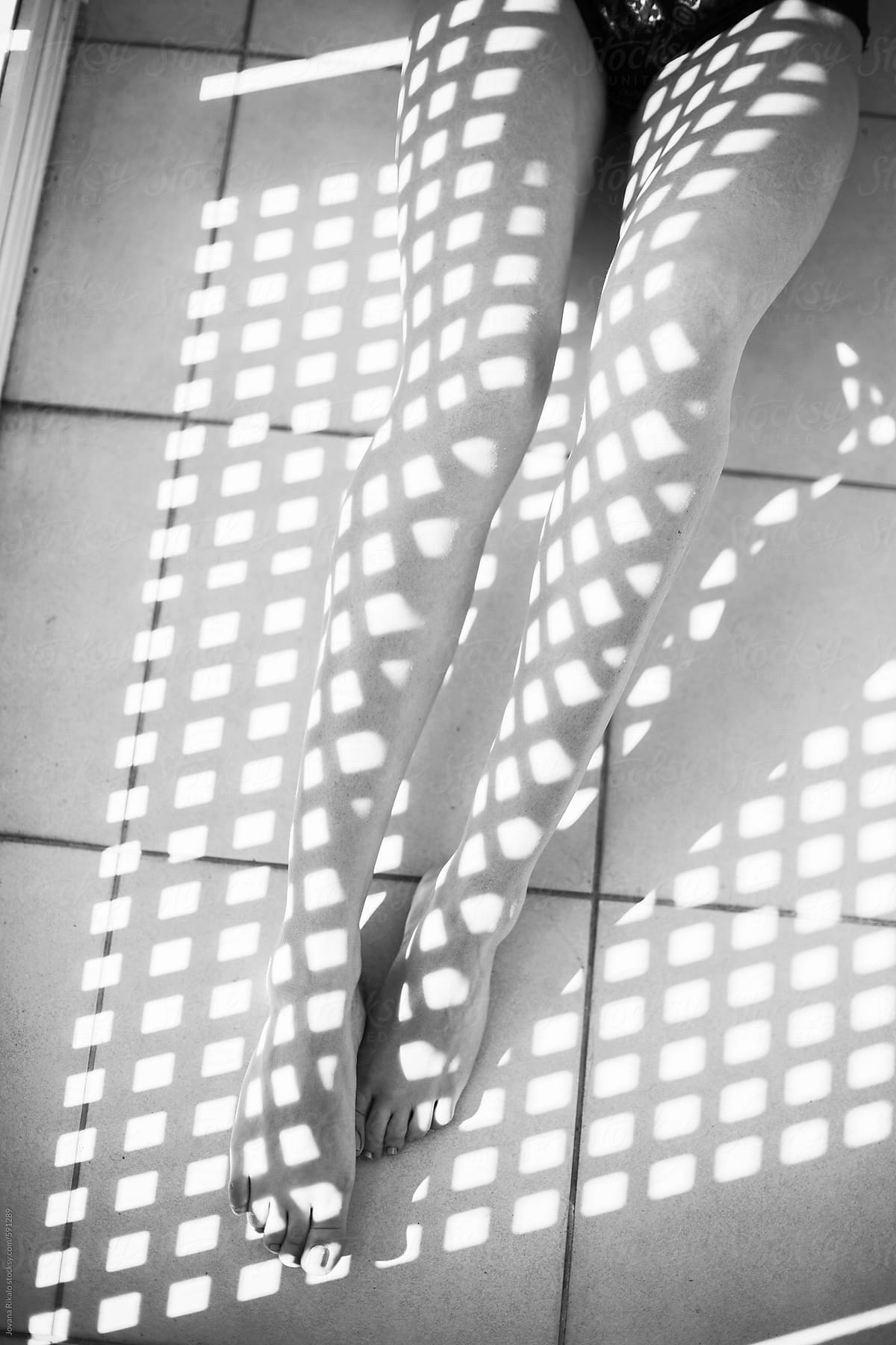 Shadows on a woman\'s legs