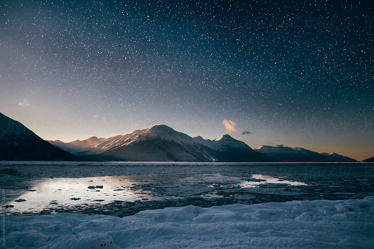 A Frozen Beach Laying Still Underneath a Starry Night