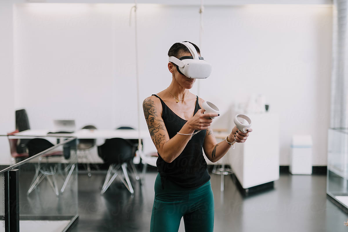 Woman wearing VR goggles touching air