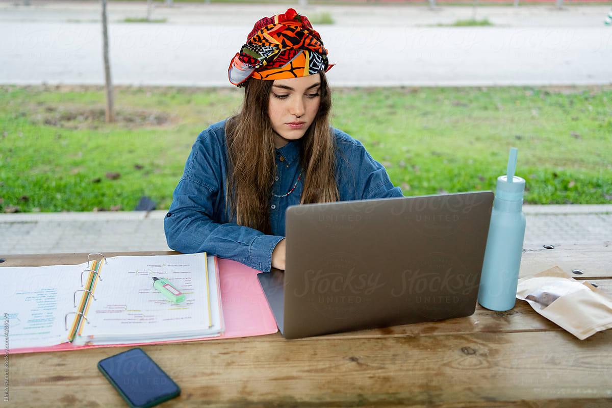 Smart woman using laptop at university campus