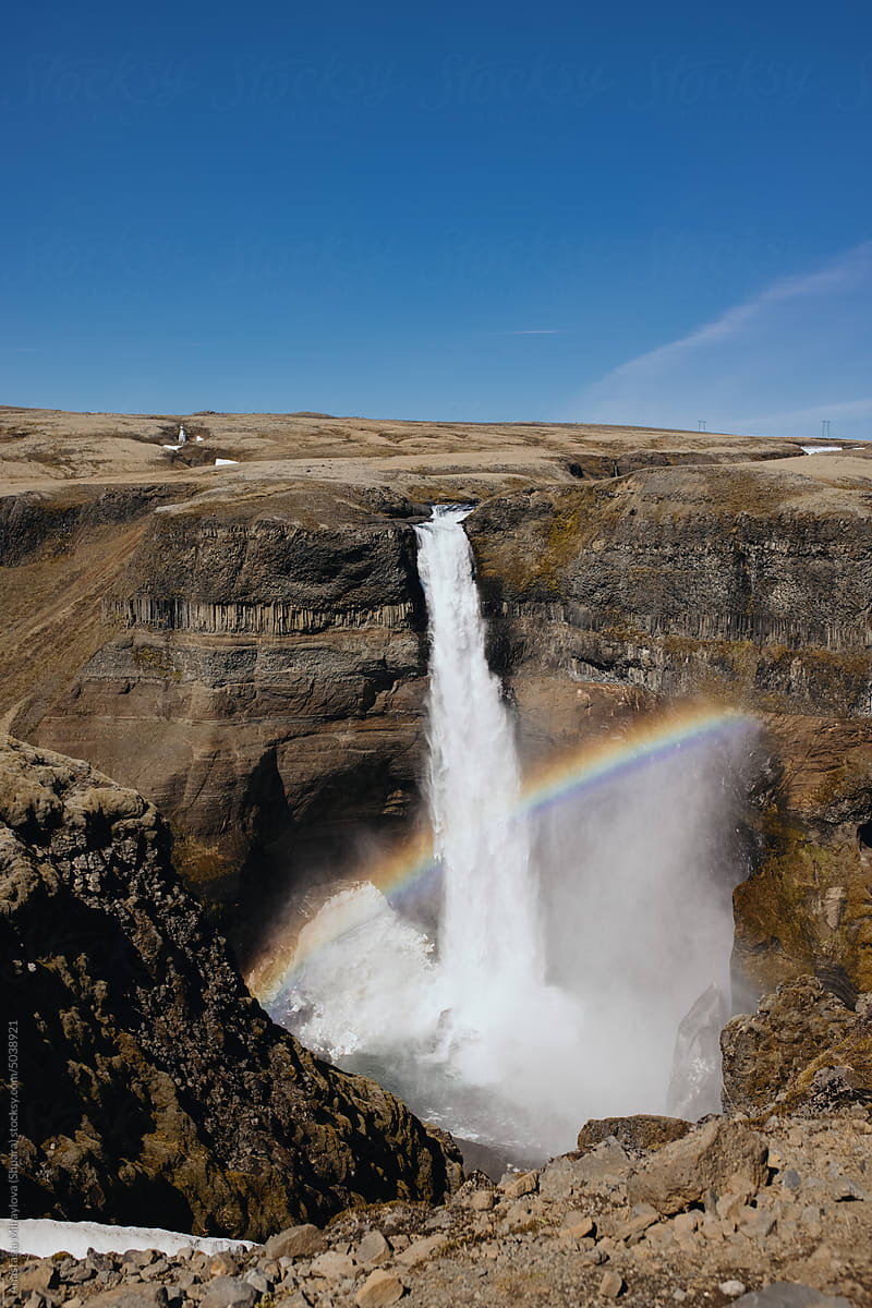A Huge Waterfall In Iceland with rainbow