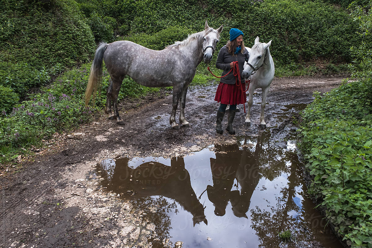 horsewoman with two horses