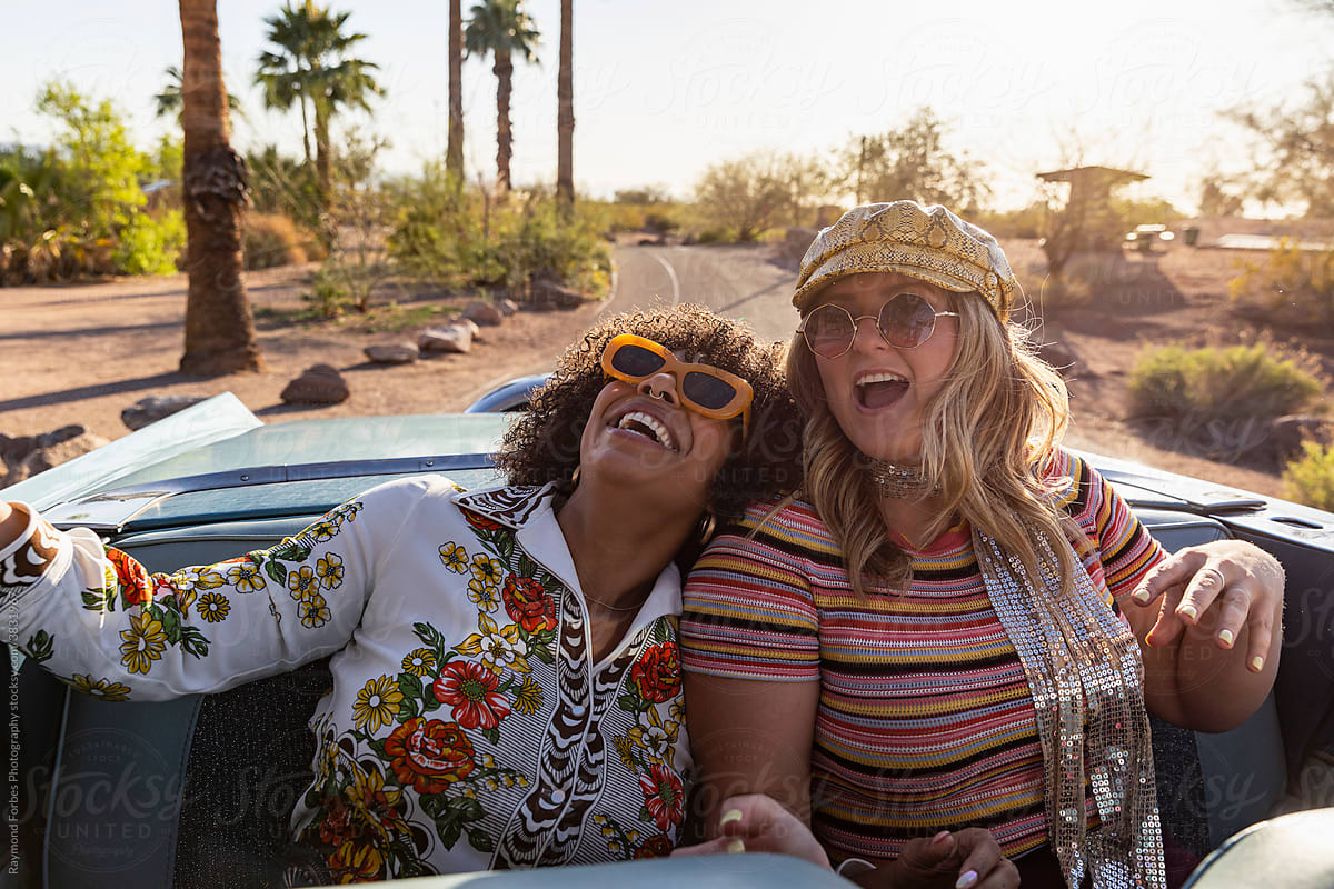 Two Girls riding in back of Convertible Car in Arizona