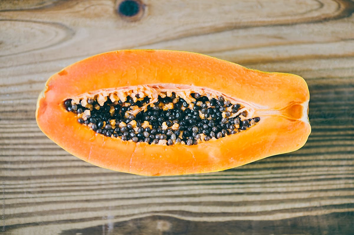 Inside of a Papaya on Wood Background
