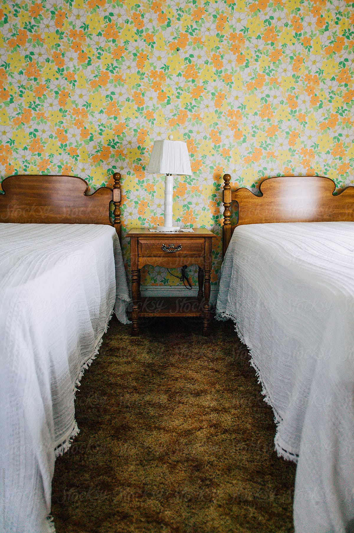 Vintage Outdated Motel Room bed with vintage wallpaper