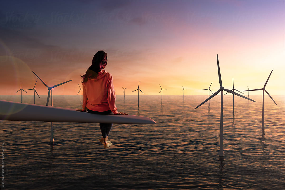 Woman sitting at sustainable windmills offshore