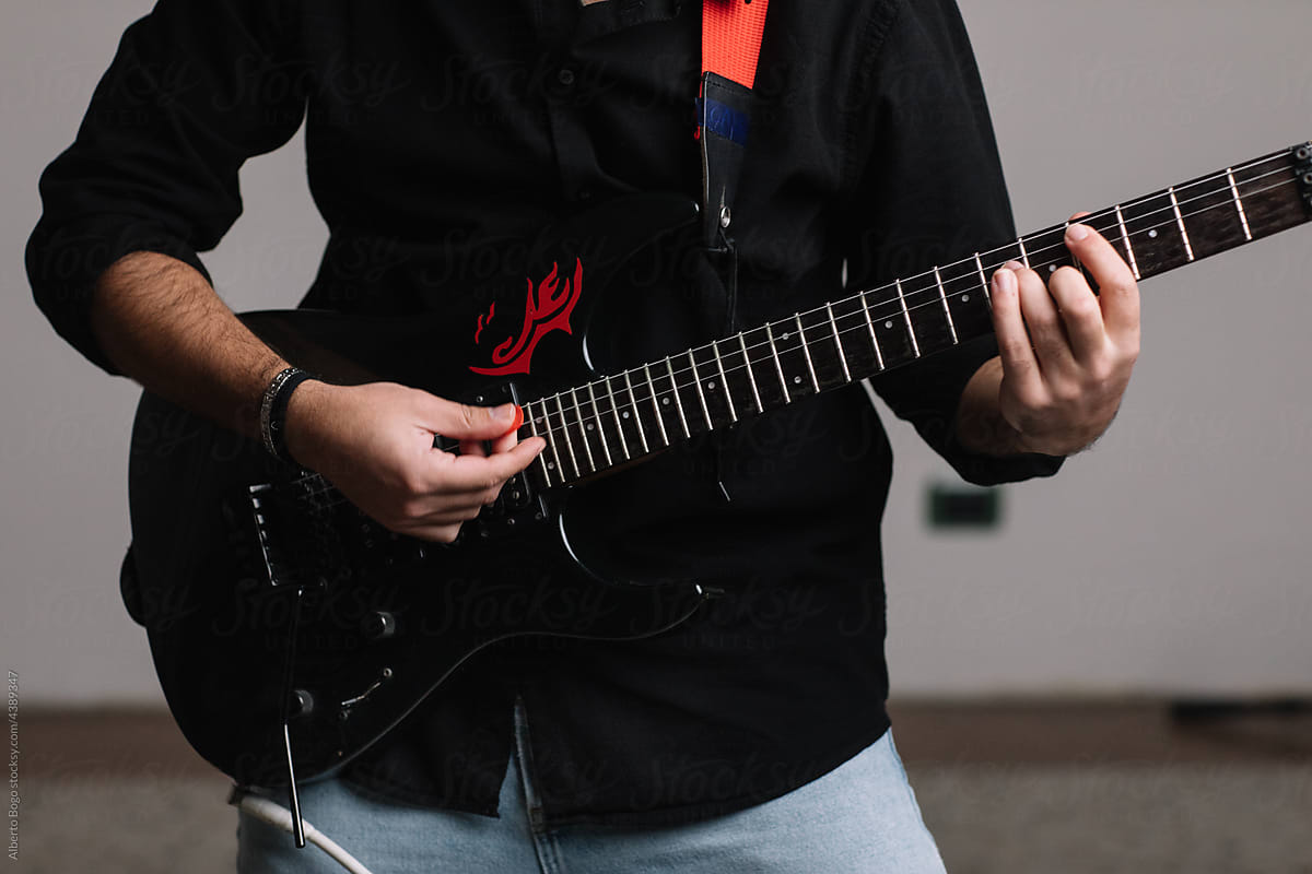 Detail Of Rock Artist Playing Electric Guitar In Studio