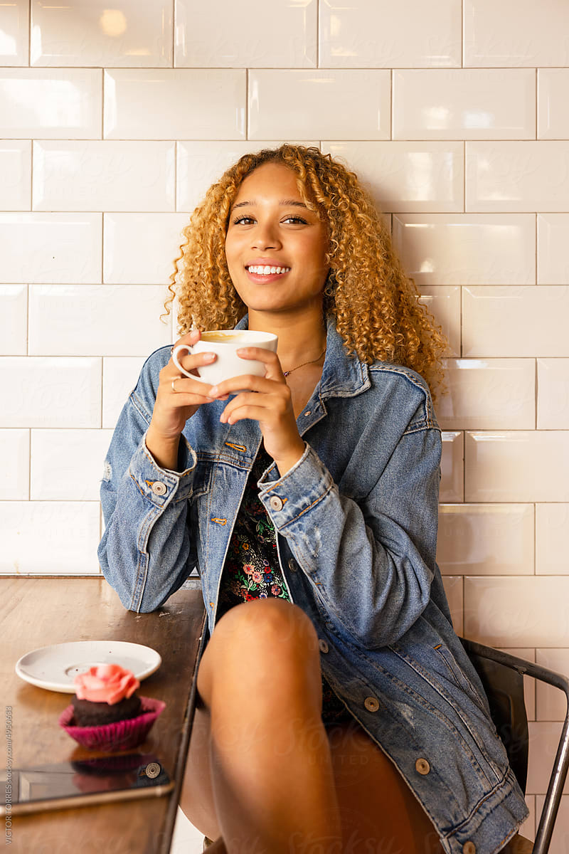 Smiling woman with cup of coffee