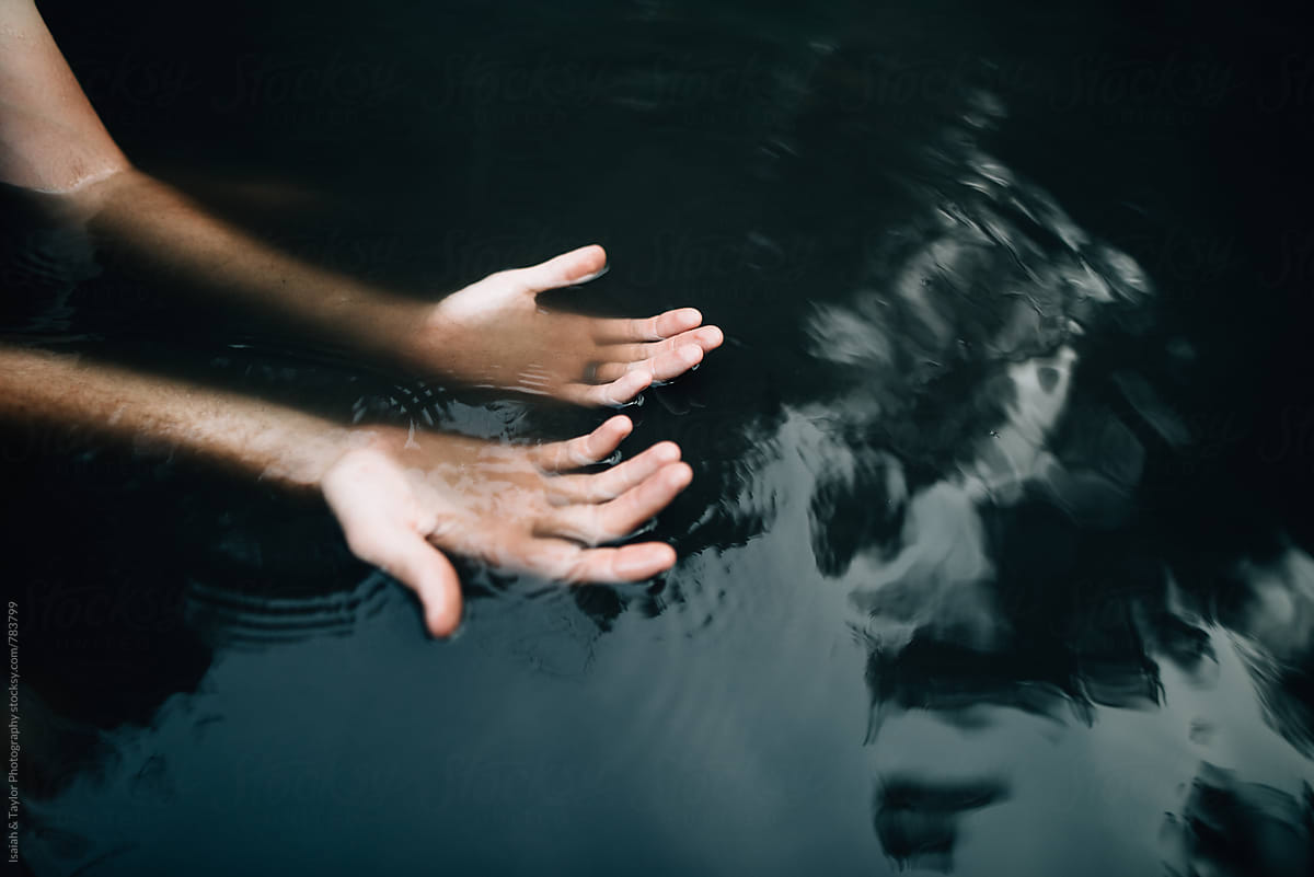 Hands in a body of water