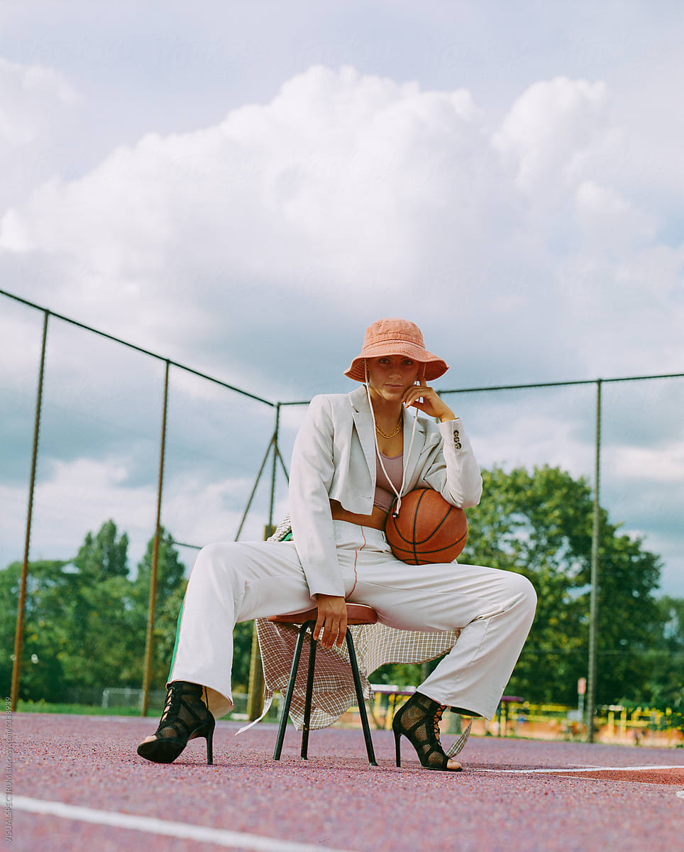 Hip Woman Posing In Streetwear On Basketball Court