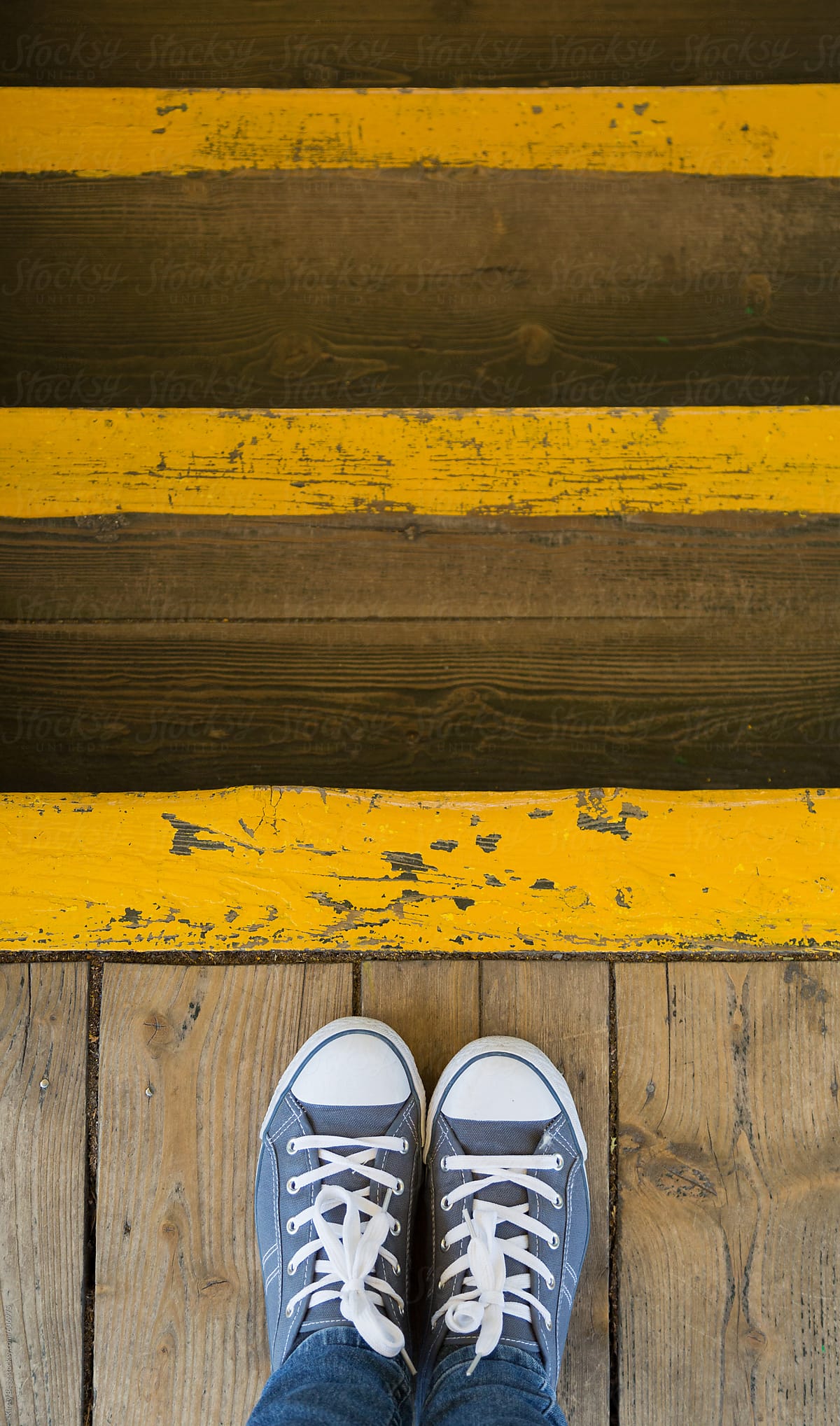 Feet at the top of wooden painted stairs