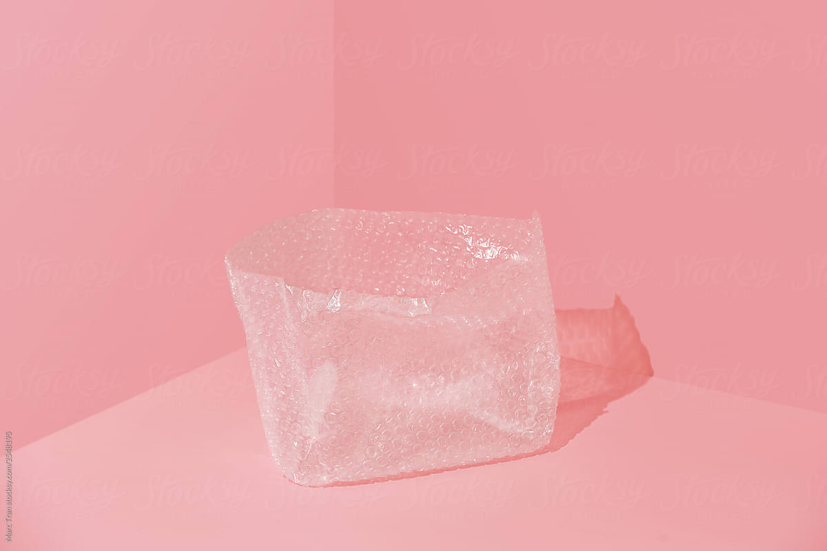Transparent plastic bag on pink background.