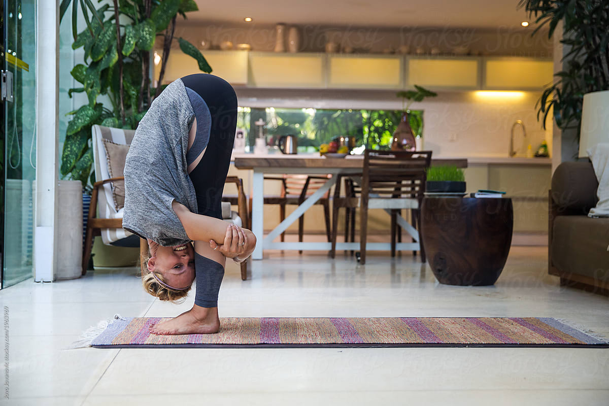Flexible woman folded in half in yoga pose